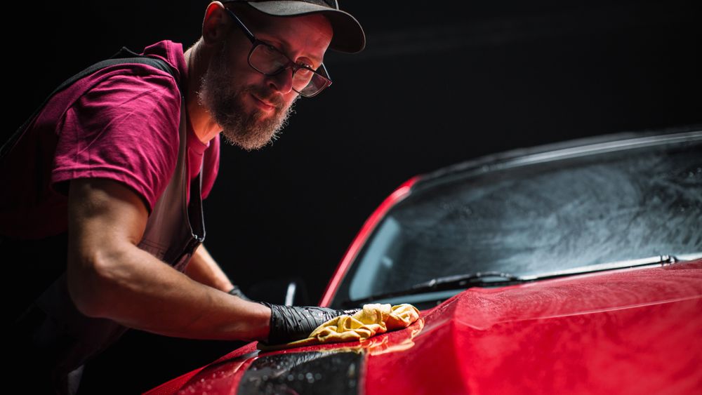 Adult Man Cleaning Away Dirt, Preparing an American Muscle Car for Detailing.