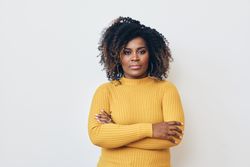 Confident Black woman standing with her arms crossed