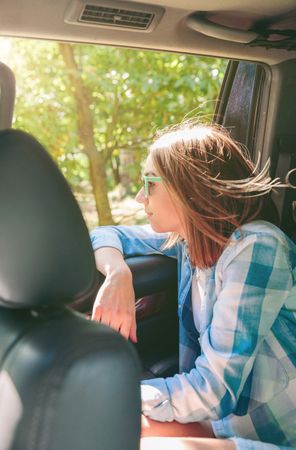 Young woman looking landscape through the window car