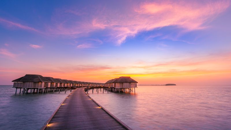 Sunset with overwater bungalows