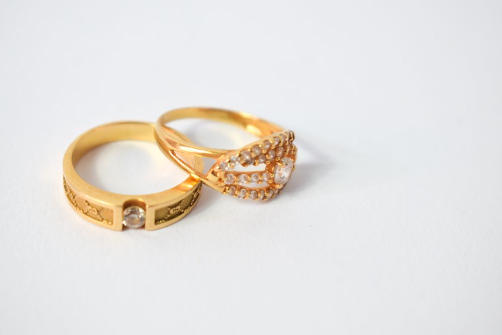 Two wedding diamond rings together on plain table with copy space