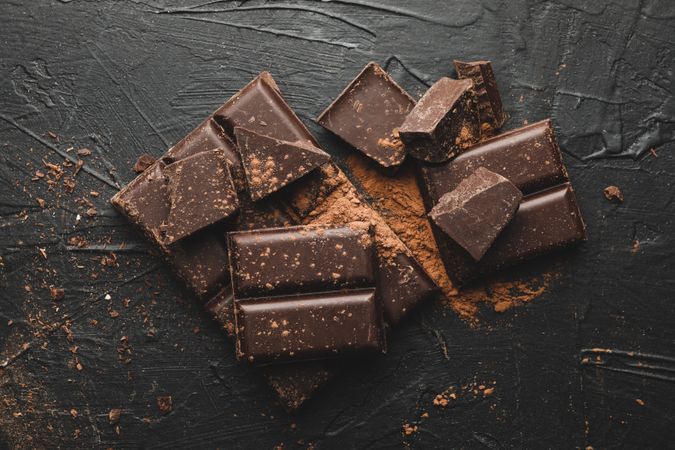 Tasty chocolate and powder on blank background
