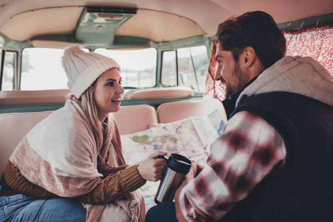 Young man and woman traveling in the camper van