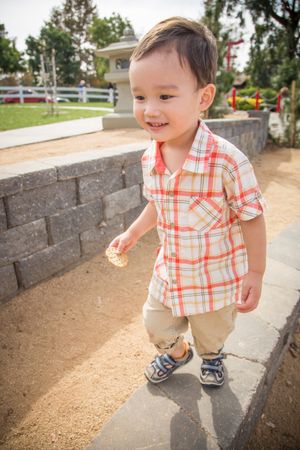 Young Biracial Boy Smiling at the Park.
