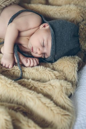 Baby girl with pompom hat sleeping