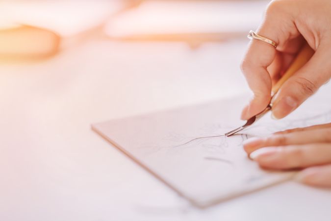 Woman doing linearity on paper at table