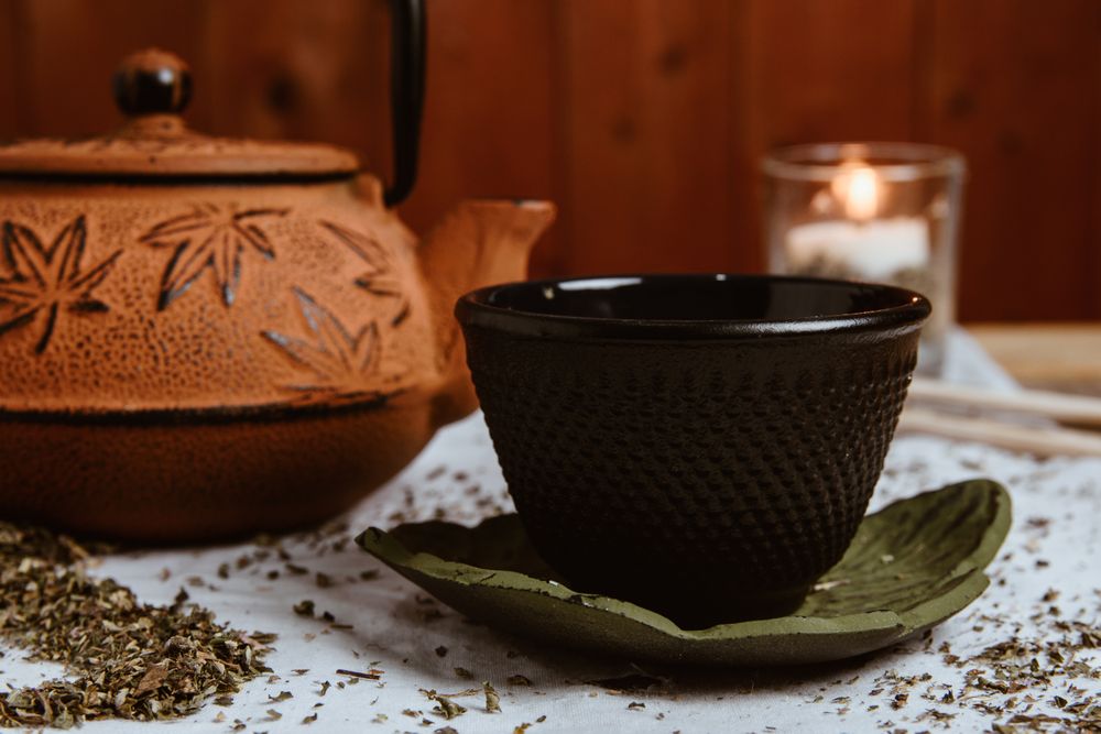Aromatic tea dates and clay teapot on table