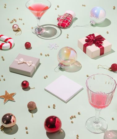 Scene of holiday items with wine glasses, presents, baubles and decorations