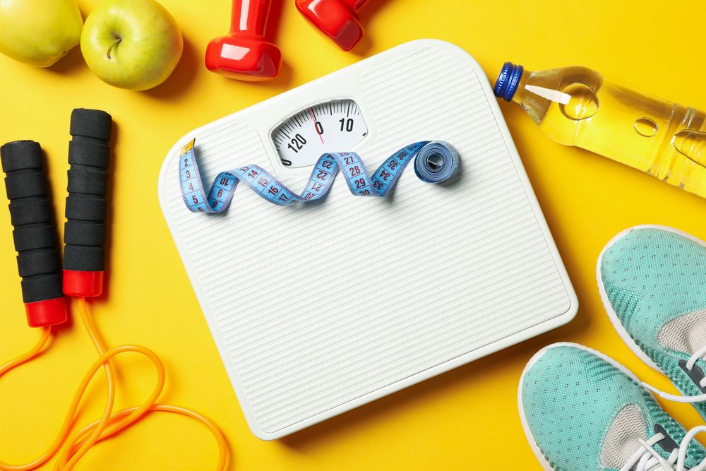 Weight loss or healthy lifestyle accessories on yellow background