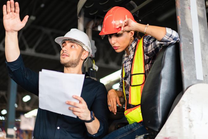 Two colleagues reviewing instructions in distribution center