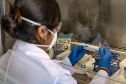 Female scientist checking numbers on equipment during an experiment