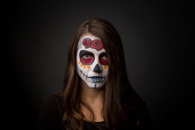 Young woman with creepy face paint