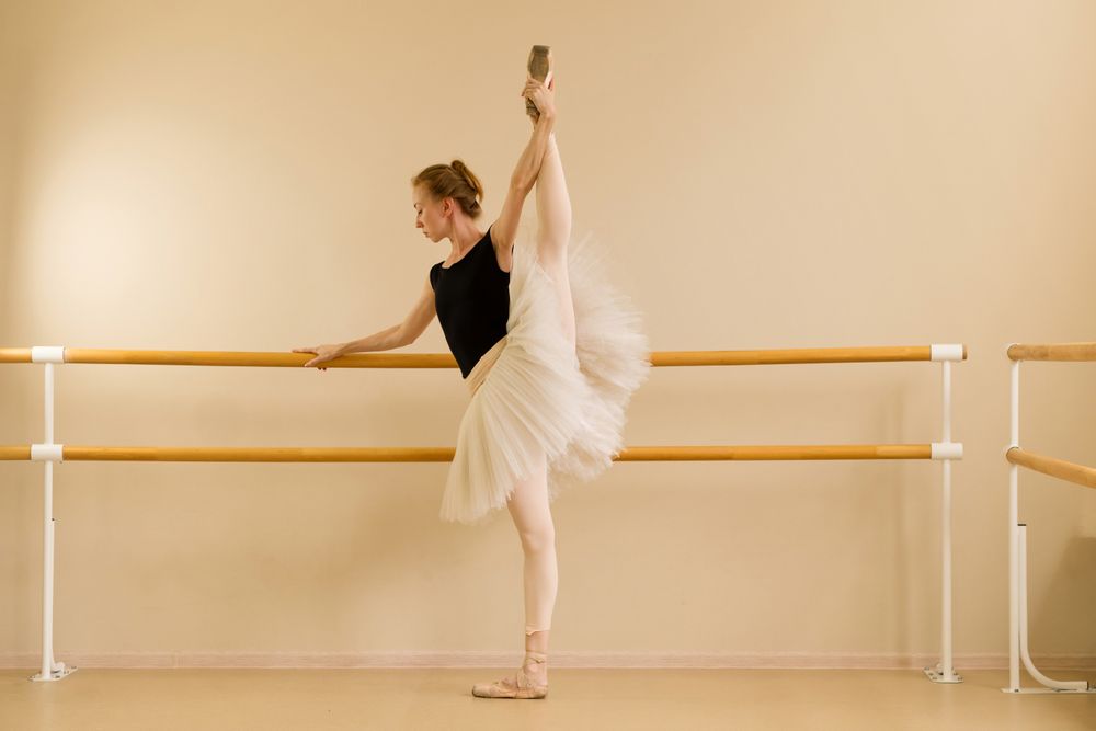 Ballet dancer maintaining high leg stretch