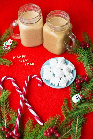 Christmas tree, candy, coffee marshmellou on a red background. The inscription Happy New Year