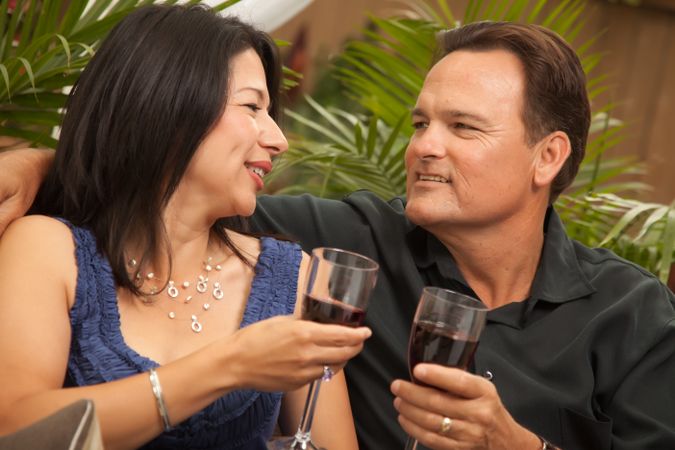 Latina and White Couple Drinking Wine