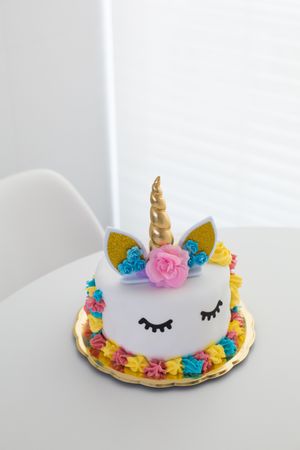 Cute unicorn cake with painted closed eyes