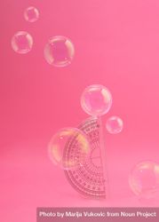 Protractor on pink background with bubbles 47BGl5