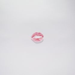 Kiss with lips red on a plain background