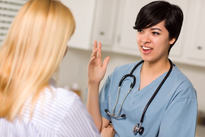 Young Female Doctor Talking with Patient