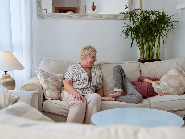 Grandmother chilling with grandson on couch