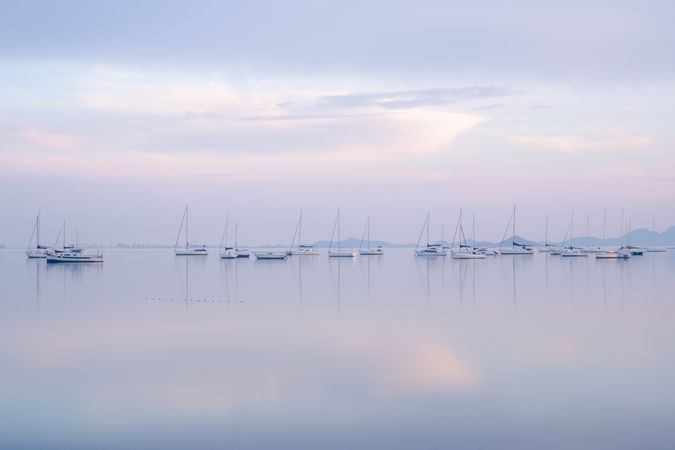Boats on calm sea water in evening
