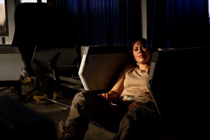 Female soldier on floor of military vehicle