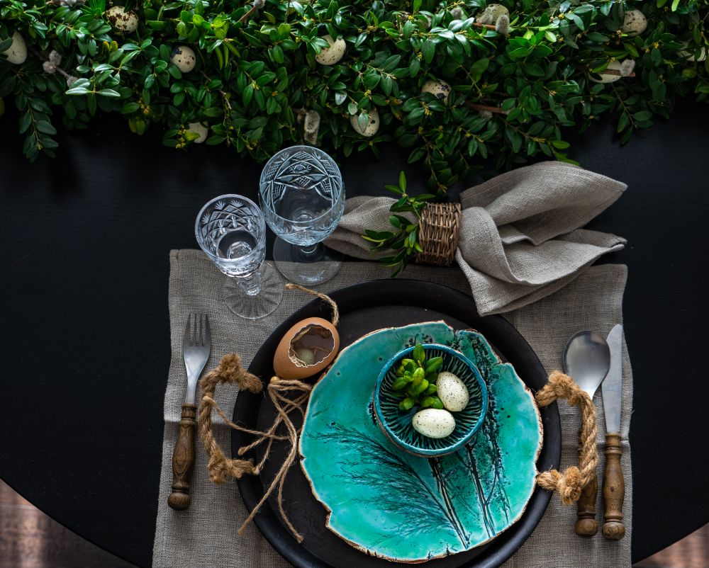 Top view of Easter table setting with decorative teal plate