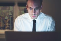 Cropped shot of man working on laptop