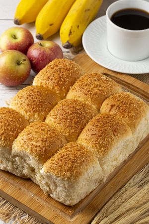 Breakfast table with coconut bread and fruits.