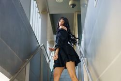 Dancer moving sensually standing on urban stairs