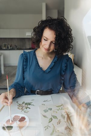 Woman painter working at home