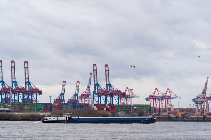 Cargo ship docked beside crane at seaport in Hamburg, northern Germany