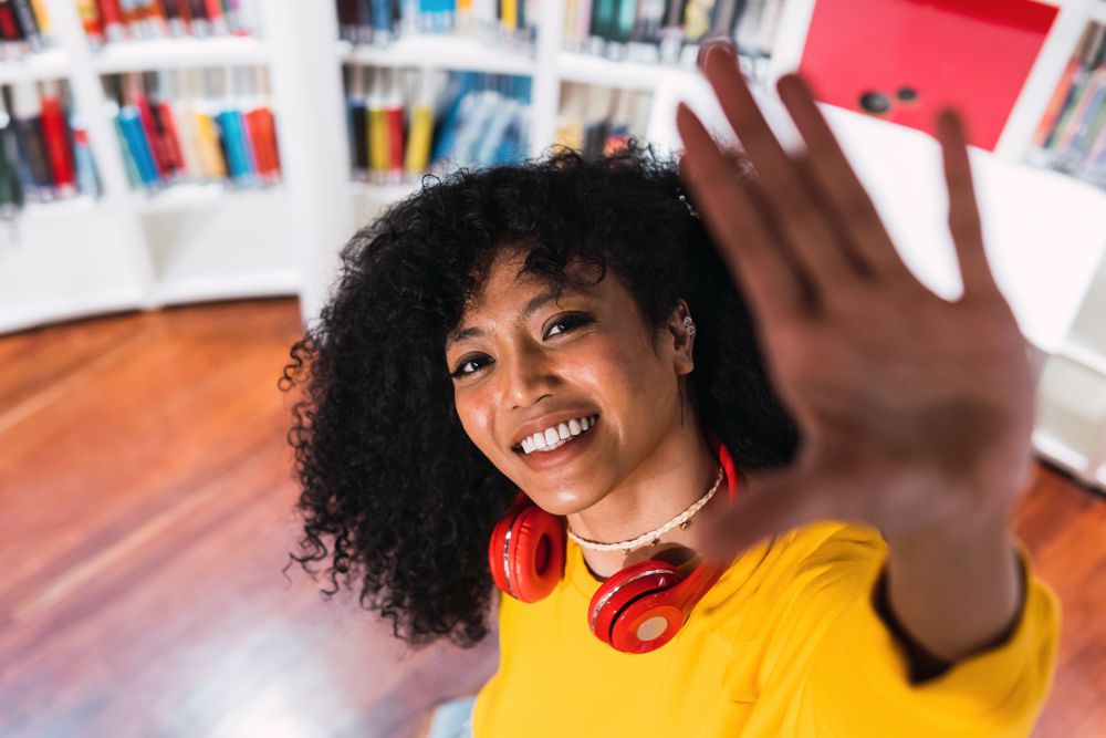 Portrait of cheerful Black woman in headphones