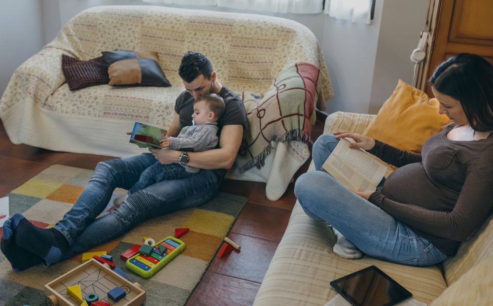 Family reading books in the living room