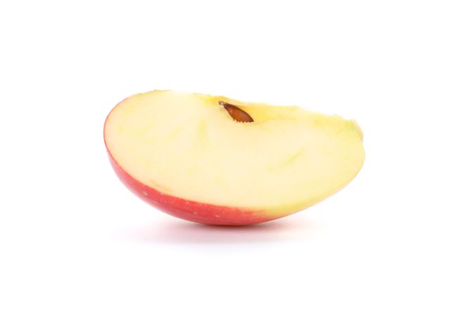 Slice of red apple isolated on light background