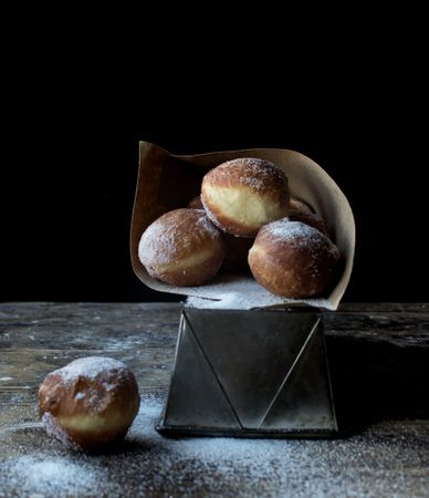 Baked cakes in craft paper on table