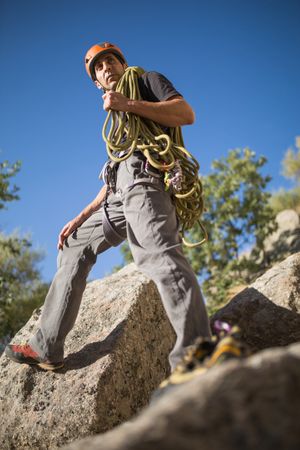A climber is preparing his ropes to start climbing