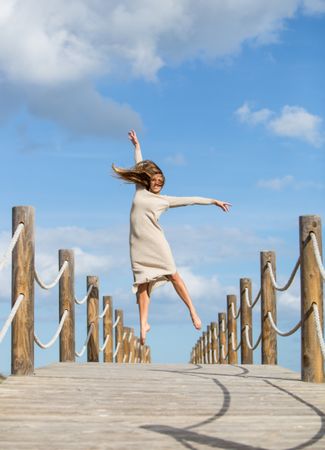 Young woman posing on footbridge