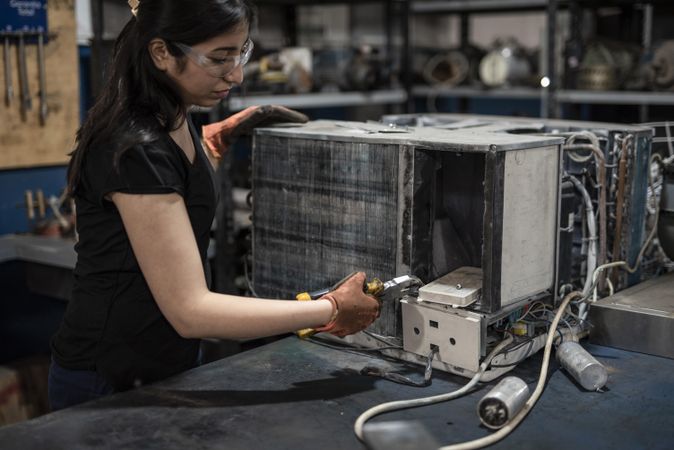 Woman fixing heavy machine