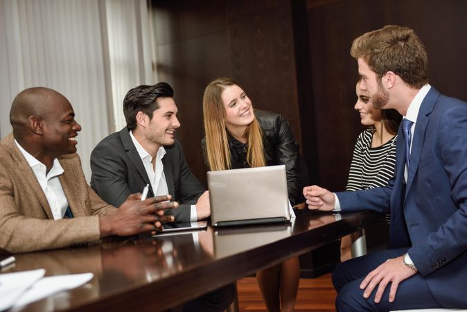 Woman leading her co-workers in a brain storming meeting at work