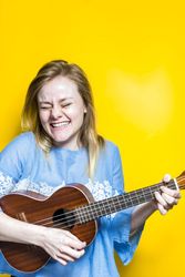 Woman enjoying playing ukulele