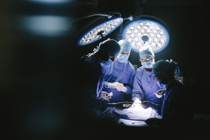Team of professional surgeons performing surgery in hospital