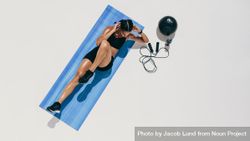 Top view of a female athlete doing abdomen exercises bD2pJ5