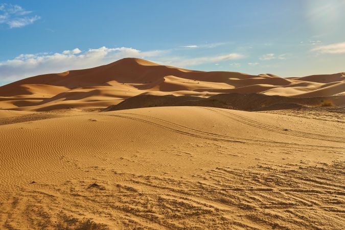 Sand dunes and blue sky with sun