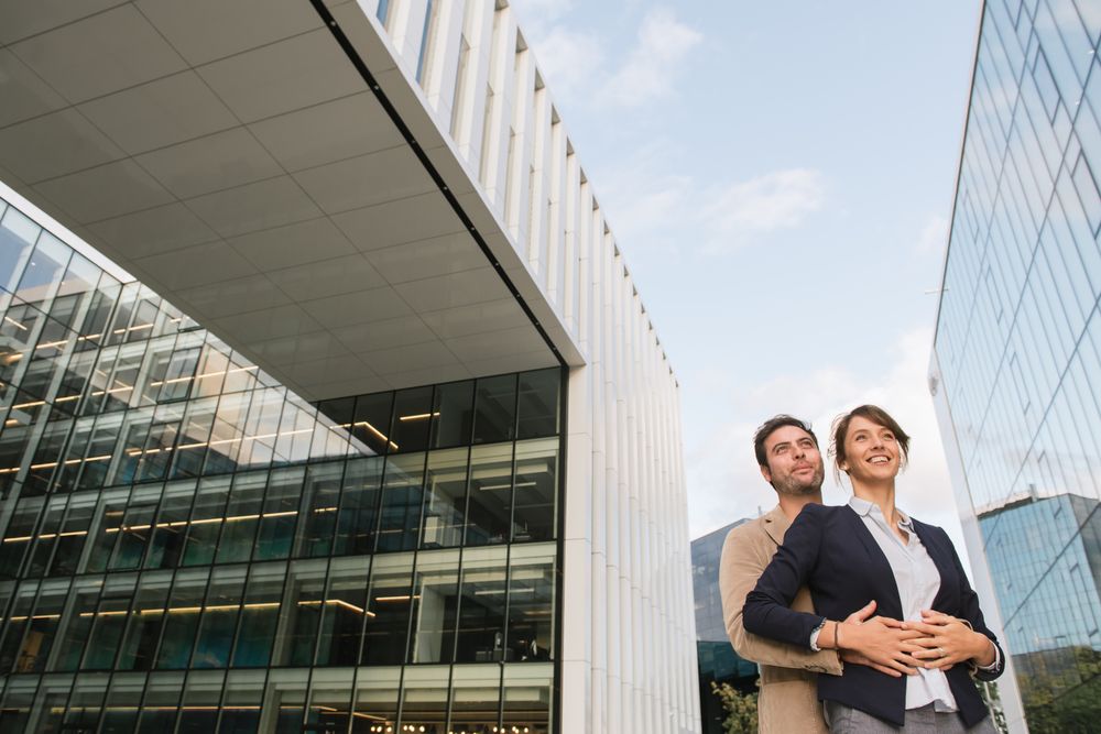 Businesspeople couple outside contemporary building