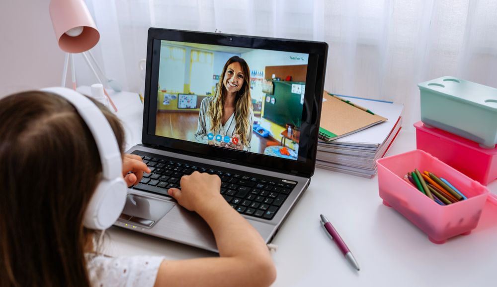 Laptop with teacher teaching class via videoconference