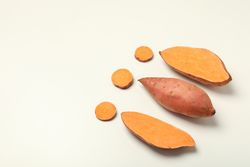 Fresh cut sweet potato on a light background