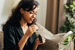 Woman with a bottle of serum