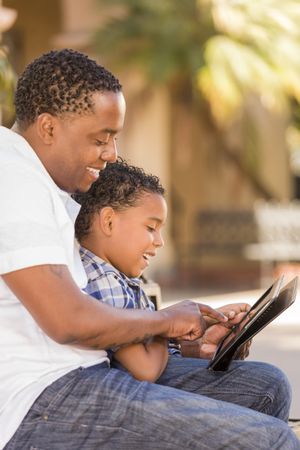Father and Son Using Touch Pad Computer Tablet