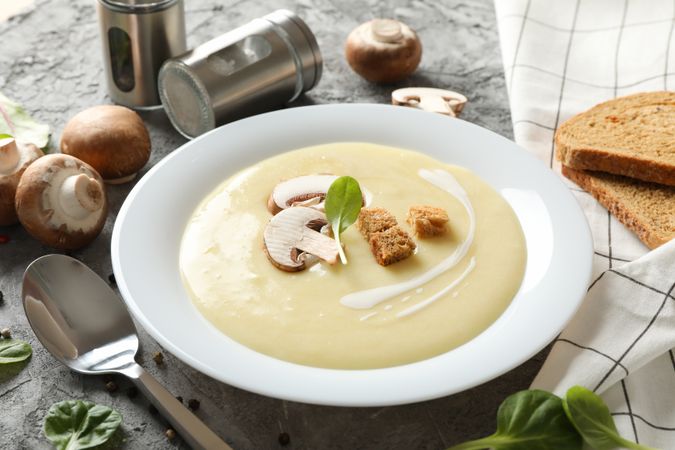 Bowl of mushroom soup on marble table